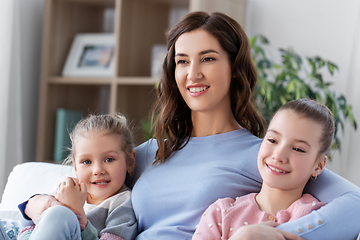 Image showing happy smiling mother with two daughters at home