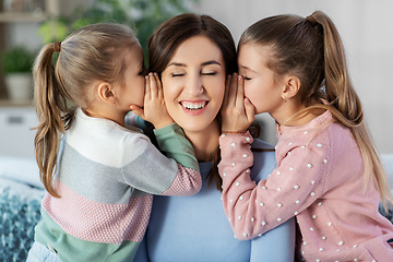 Image showing happy mother and daughters gossiping at home