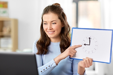 Image showing teacher with clock having online class at home