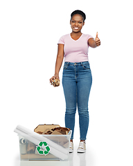 Image showing happy african american woman sorting paper waste