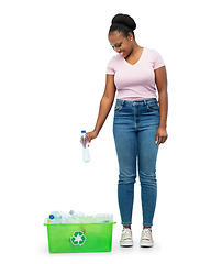 Image showing smiling young asian woman sorting plastic waste