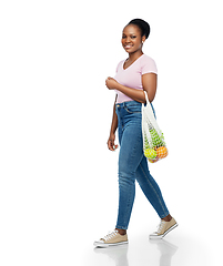 Image showing african woman with food in reusable string bag