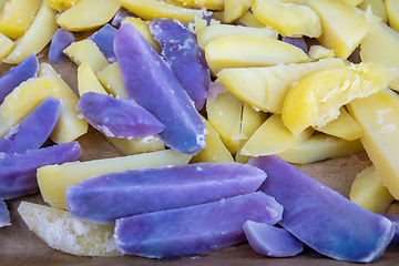 Image showing Raw sliced blue and yellow potatoes