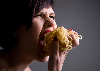 Image showing Young person eating tasty noodles