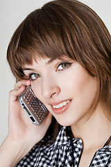 Image showing a portrait of attractive young women talking on cellular phone.