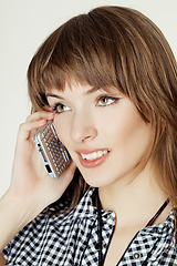 Image showing a portrait of attractive young women talking on cellular phone.