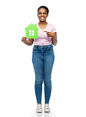 Image showing smiling african american woman holding green house