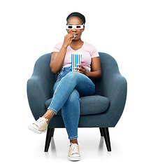 Image showing woman in 3d movie glasses eating popcorn in chair