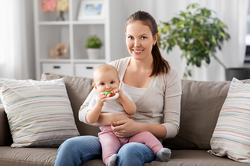 Image showing mother and little baby with teething toy at home