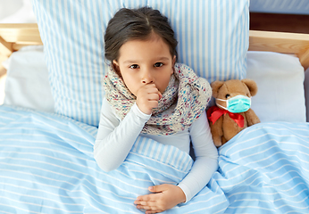 Image showing sick coughing girl with teddy bear lying in bed