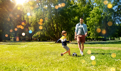 Image showing father with little son playing soccer at park