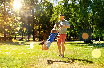 Image showing happy father with son playing in summer park