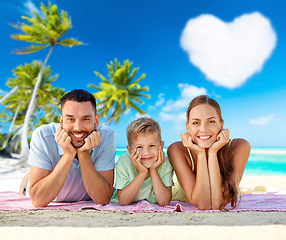 Image showing happy family lying over tropical beach background