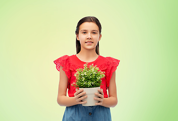 Image showing happy smiling girl holding green flower in pot
