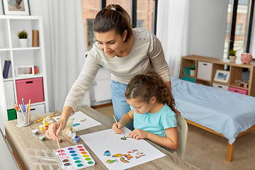 Image showing mother with little daughter drawing at home