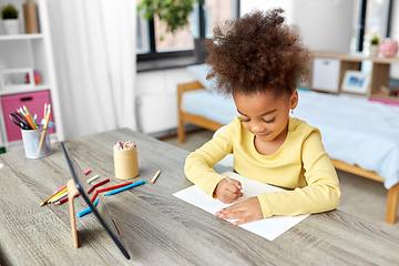 Image showing little girl drawing with coloring pencils at home