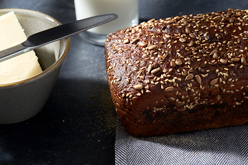 Image showing close up of bread, butter, knife and glass of milk