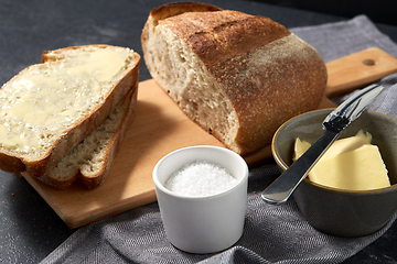 Image showing close up of bread, butter, knife and salt on towel