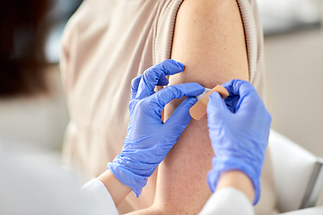 Image showing close up of doctor attaching patch to patient