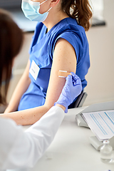 Image showing doctor attaching patch to medical worker