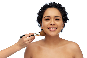 Image showing happy woman and hand of make up artist with brush