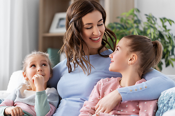 Image showing happy smiling mother with two daughters at home