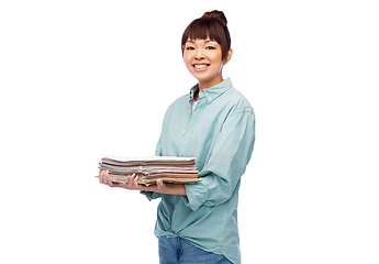 Image showing smiling young asian woman sorting paper waste