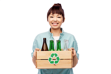 Image showing smiling young asian woman sorting glass waste
