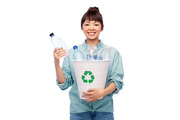 Image showing smiling young asian woman sorting plastic waste