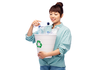 Image showing smiling young asian woman sorting plastic waste