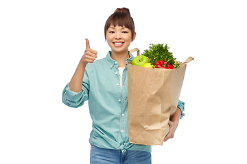 Image showing happy asian woman with food in paper shopping bag