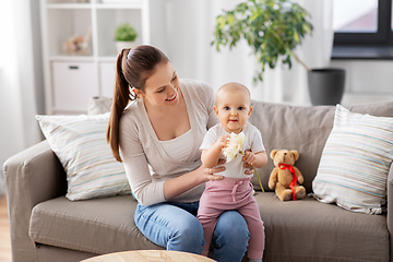 Image showing happy smiling mother with little baby at home