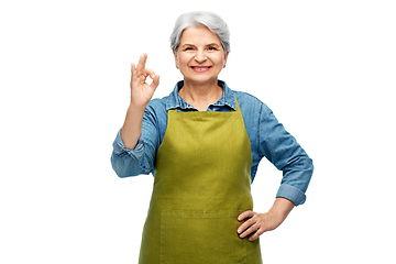 Image showing senior woman in garden apron showing ok gesture