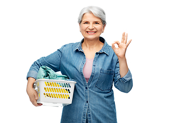 Image showing smiling senior woman with laundry basket