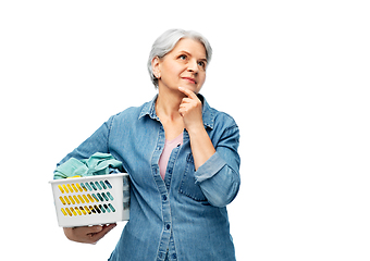 Image showing thinking senior woman with laundry basket