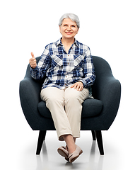 Image showing old woman sitting in chair and showing thumbs up