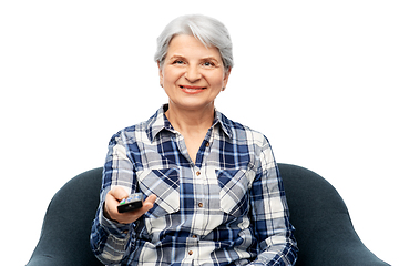 Image showing happy senior woman watching tv sitting in armchair