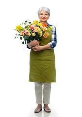 Image showing smiling senior woman in garden apron with flowers