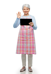 Image showing old woman in apron with tablet pc has video call