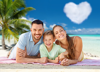 Image showing happy family lying over tropical beach background