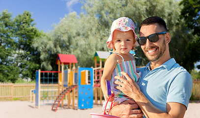 Image showing happy father with little daughter on playground