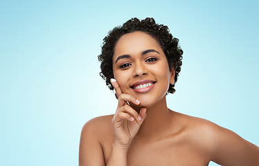 Image showing young african american woman with moisturizer