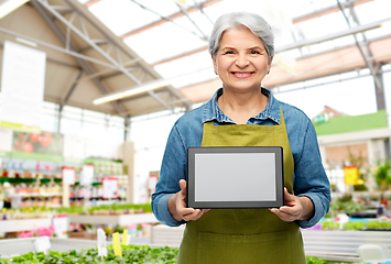 Image showing happy senior woman with tablet pc at garden store