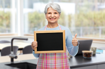 Image showing old woman in apron with menu showing thumbs up