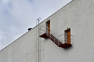 Image showing wall of the house with a staircase and doors