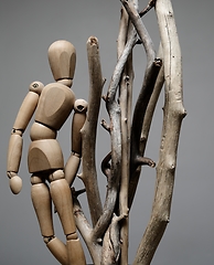 Image showing wooden artist model and dry tree branches