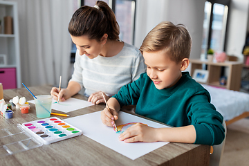 Image showing mother and son with colors drawing at home