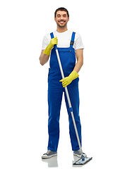 Image showing male cleaner in overall cleaning floor with mop