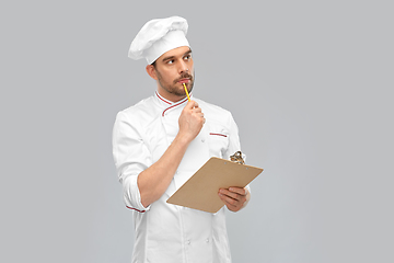 Image showing thinking male chef with clipboard