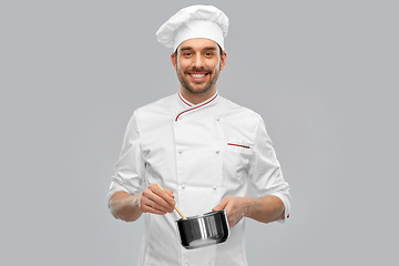 Image showing happy smiling male chef with saucepan cooking food